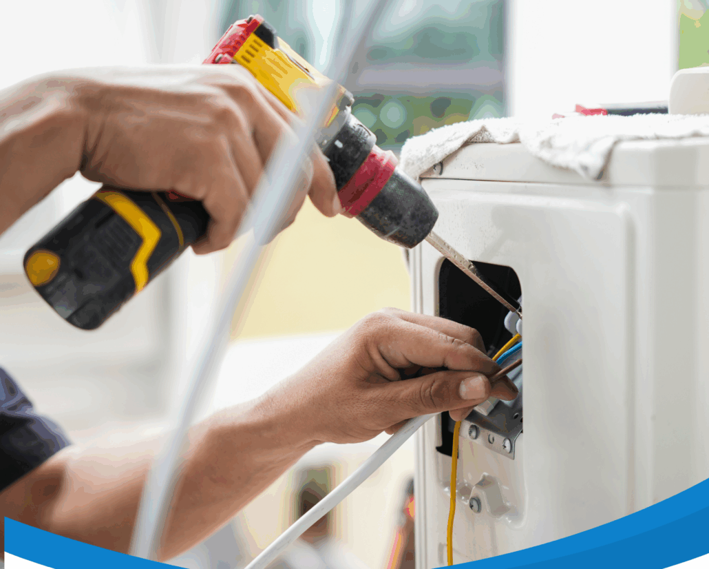 HVAC technician using a power drill and tools to repair wiring inside an air conditioning unit.